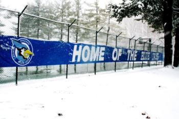 snowy fence with banner 'home of the blue jays'