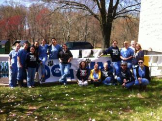 group wearing blue in front of 'dental' banner