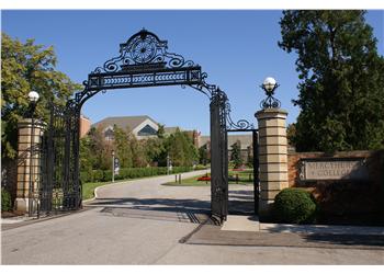 ornate metal gate entrance with brick columns
