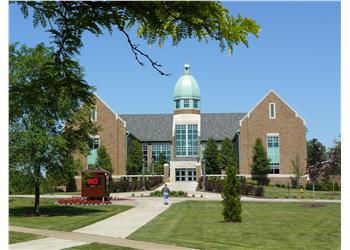 campus building with a green dome under blue sky