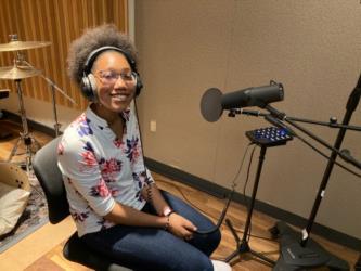 smiling student in a recording studio