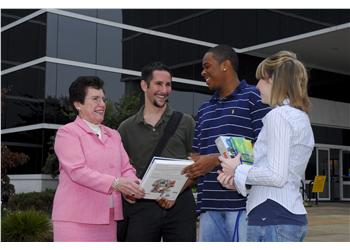 students conversing outside campus building