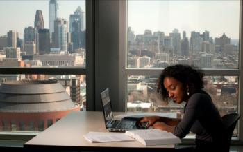 student working with skyline view