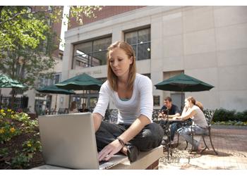 student studying outdoors with laptop