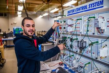 student working on electrical panel