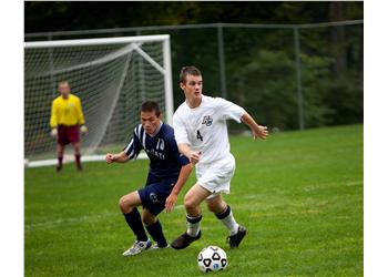 soccer players competing on the field