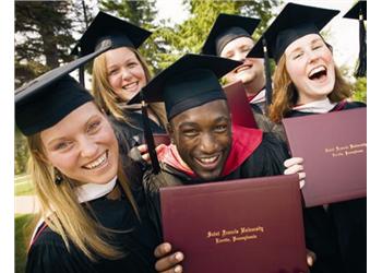 graduates laughing with diplomas