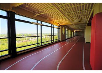 indoor track with large windows and a view outside