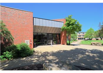 entrance to a brick building with trees