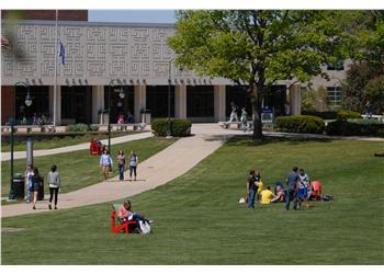 campus view with students lounging and walking