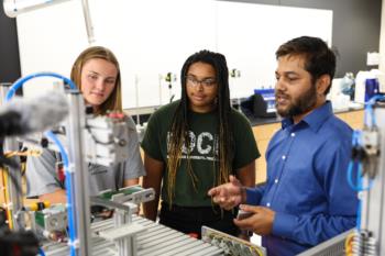 students and instructor with lab equipment