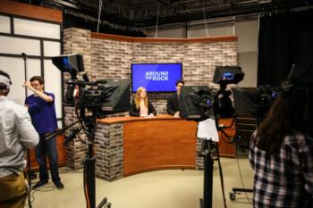 tv studio setup with 'around the block' on screen