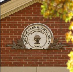 university seal on brick wall