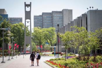 walkway with bell tower and high rise buildings