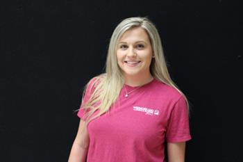 smiling student in branded t-shirt