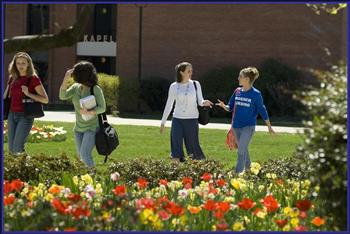 students walking on campus with flowers