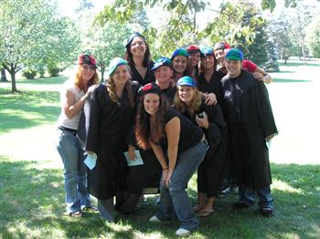 group in graduation attire with red caps