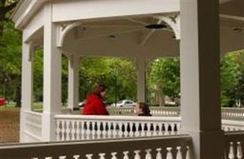 two people conversing in a gazebo