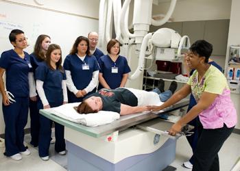 group of medical students with instructor and patient