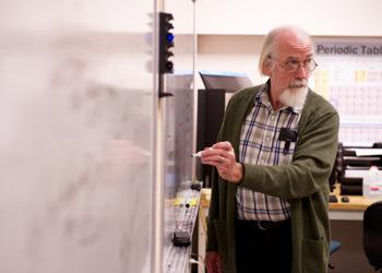 teacher with whiteboard and periodic table