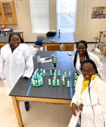 scientists presenting hand sanitizers on table