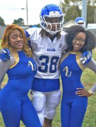 football player with two cheerleaders, university attire