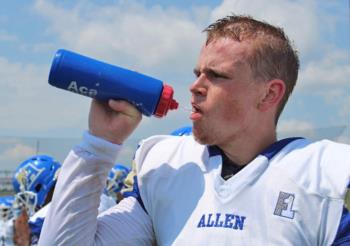 quarterback hydrating at practice