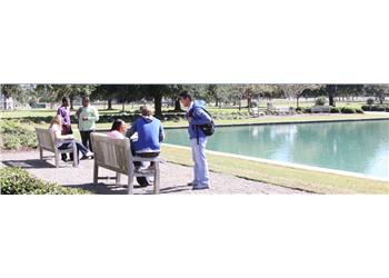 students and security officer by campus lake