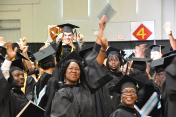 graduates celebrating with caps in air