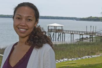 student smiling by a waterfront