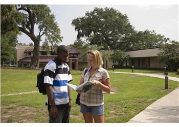 students chatting on campus walkway