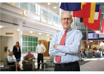 man standing in a lobby with arms crossed