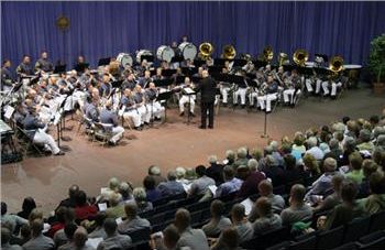 conductor leading an orchestra with audience