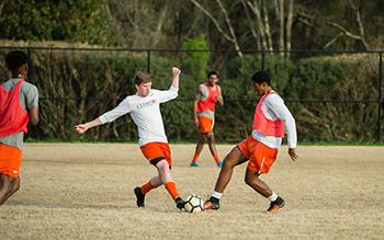 students playing a soccer match on outdoor field