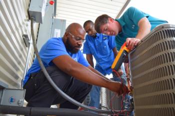 students learning hvac skills with instructor