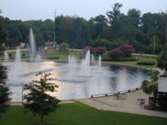 scenic view of fountains in a pond at dusk