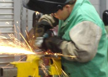 student welding in workshop