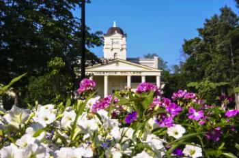 flower foreground with a limestone college building