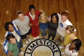 students standing on limestone college seal