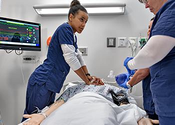 nursing students practicing in a simulation