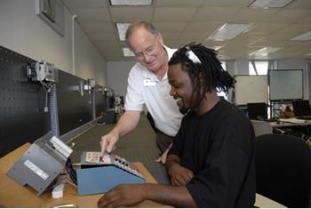 two people working on electronic equipment