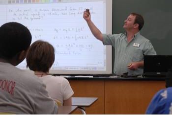 instructor teaching mathematics on a whiteboard