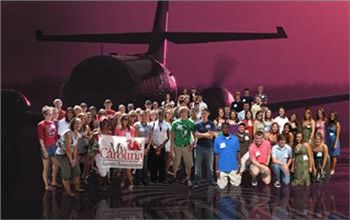 group photo with a helicopter and banner