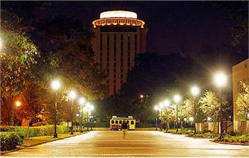 night view of a lit building and shuttle bus