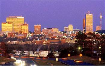 city skyline at dusk with car lights