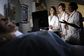 medical students observing a patient in a lab