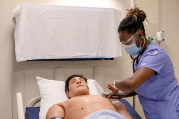 nursing student with mannequin patient