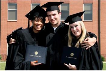 graduates smiling with diplomas