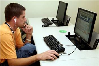 student studying at a computer desk