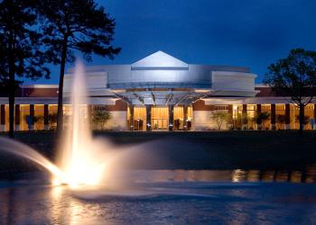 illuminated building and fountain at dusk